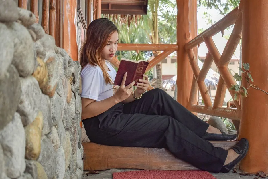Young woman reading her Bible outdoors — grounded in who God says she is before the day begins