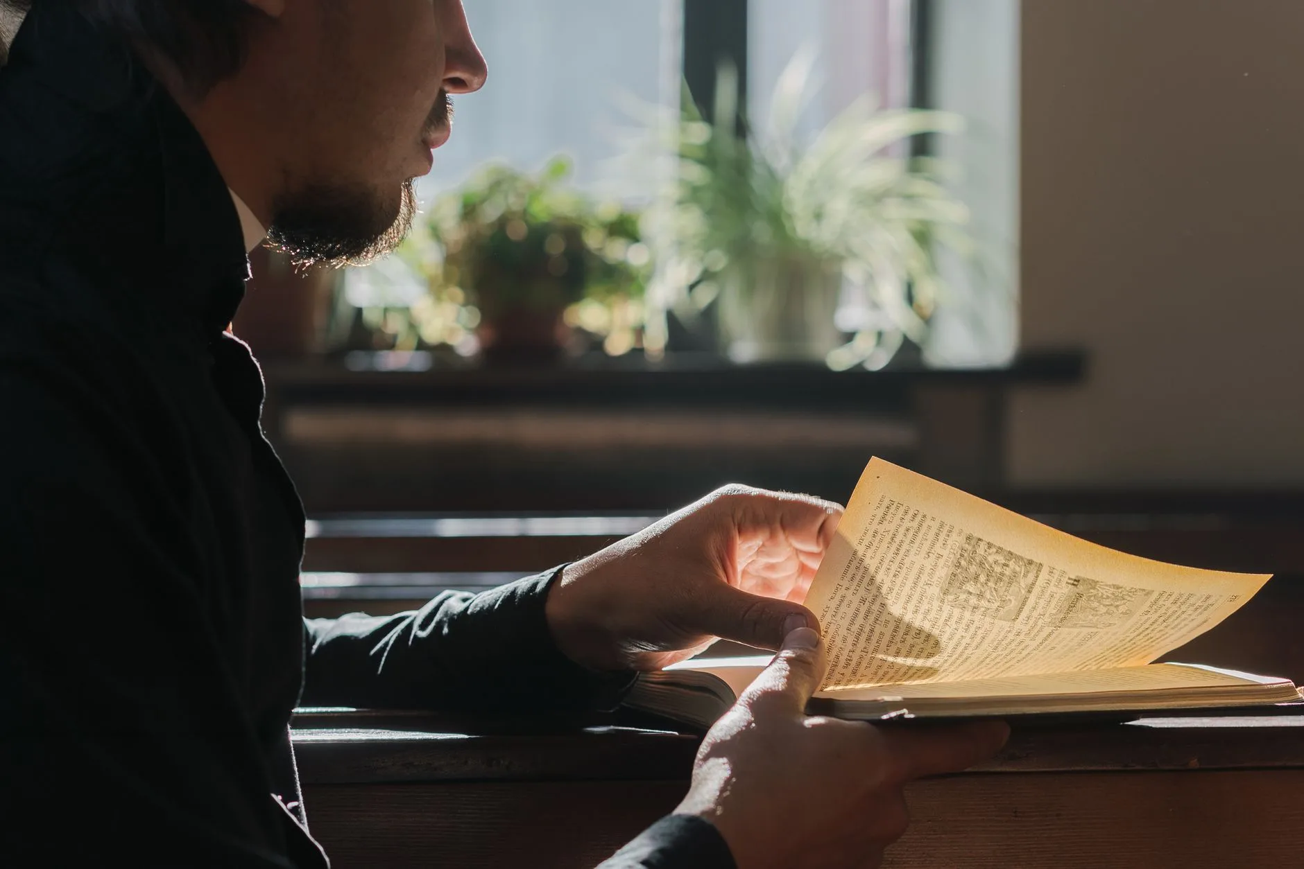 Open Bible in morning light — a man anchored in Scripture before the day begins
